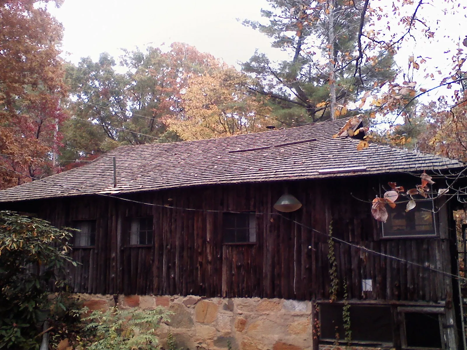 Weathered wood shake roof on a rustic board sided cabin in Onset